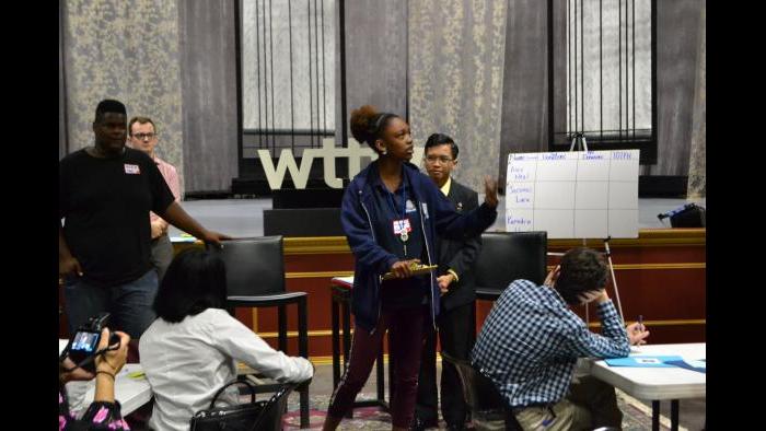 Kenedra Hood (center) delivers her gubernatorial campaign speech during an activity. (Kristen Thometz / Chicago Tonight)