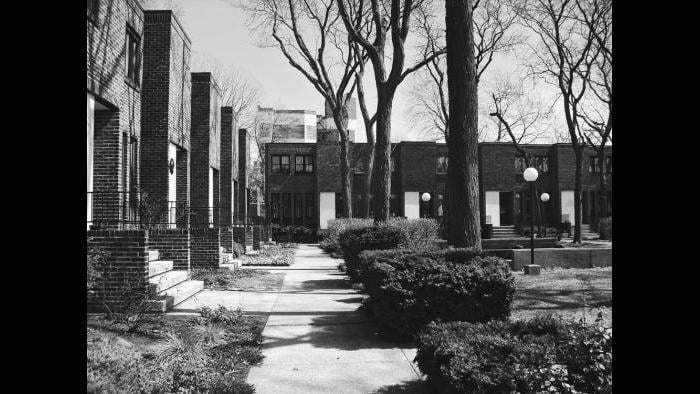 Ezra Gordon lived in Madison Park for seven years and recalled that the community was “badly deteriorated” during the years prior to urban renewal. After working for Harry Weese, he bid on sites in Hyde Park, independently and was awarded two. These compromised the Commons, a development conceived to exist in concert with the surrounding neighborhood.