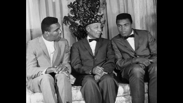 After winning the heavyweight title, Ali announced his loyalty to the Nation of Islam and Elijah Muhammad. Elijah honored the boxer with a new name, Muhammad Ali. Rudy Clay, left, also joined the Nation and became Rahaman Ali. (© Lowell K. Riley)  