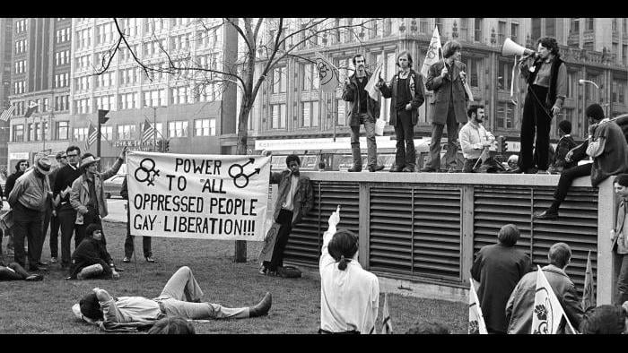 Gay-liberation rally in Grant Park, April 1970, with New York activist Martha Shelley addressing the crowd through a megaphone. (Margaret Olin)