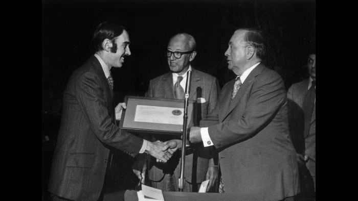 Chuck Renslow (left) receives plaque from Mayor Richard L. Daley commemorating city-council designation of Dewes Mansion as historic landmark, 1974. (Courtesy of Chuck Renslow)