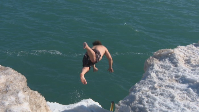 Dan O’Conor dives headfirst into Lake Michigan at Fullerton Beach on Feb. 26, 2021. O’Conor said it was his 159th consecutive day of swimming in the lake. (WTTW News)