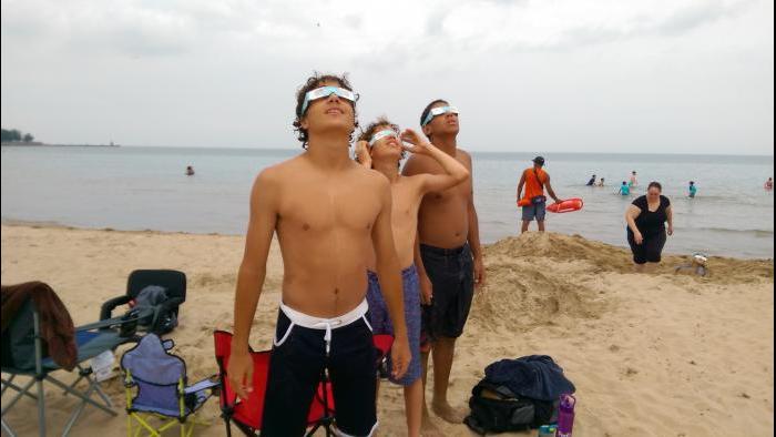 Friends & brothers watching eclipse at Foster beach. (Submitted by: CS Russell)