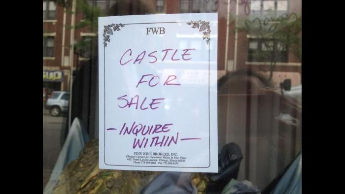 Sign advertising Fine Wine Brokers' cork castle window display (Rebecca Palmore / Chicago Tonight)