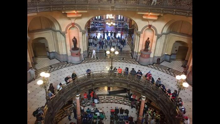 Protesters demanding a budget block Gov. Bruce Rauner’s office on Tuesday.