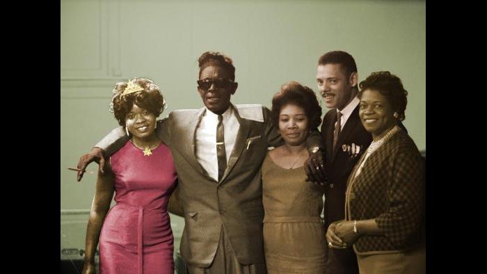 From left: Koko Taylor with Lightnin’ Hopkins and unidentified individuals at Western Hall in Chicago, April 23, 1965. Raeburn Flerlage image, colorized.