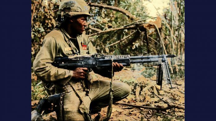 Pig, 1967. A member of the U.S. Army 25th Infantry Division fires his M60 machine gun at a tree line in the Filhol Rubber Plantation near Củ Chi.