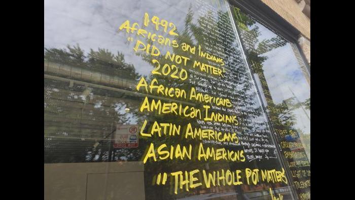 The installation “Letters to the World Toward the Eradication of Racism” in progress. (Erica Gunderson / WTTW News)