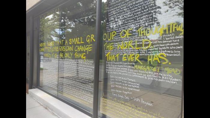 The installation “Letters to the World Toward the Eradication of Racism” in progress. (Erica Gunderson / WTTW News)