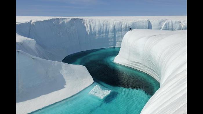 A meltwater river formed by glacier melt in Greenland. (James Balog / Museum of Science and Industry)
