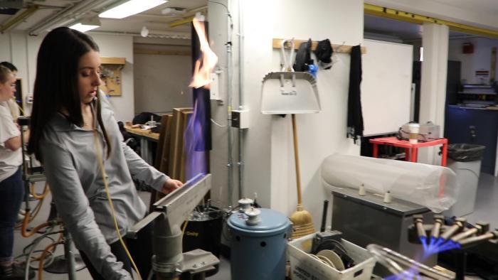 School of the Art Institute of Chicago student Tia Mitchell fires up a ribbon burner torch in Greg Mowery’s Neon Techniques class.