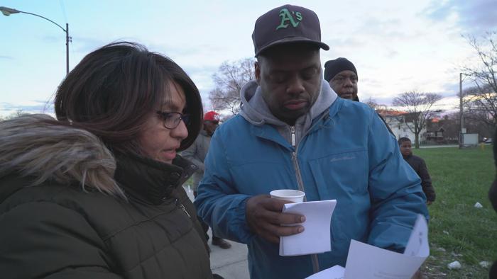 Case manager Mirella Rodriguez distributes housing applications. (Chicago Tonight)