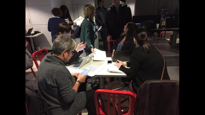 Immigration lawyers fill out G-28 forms that allow them to intervene on behalf of those detained at O'Hare airport. (Paris Schutz / Chicago Tonight)