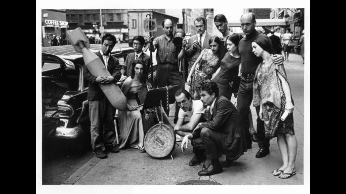 Peter Moore. Publicity photograph for 3rd Annual New York Avant Garde Festival, August 26, 1965. Left to right: Nam June Paik, Charlotte Moorman, Takehisa Kosugi, Gary Harris, Dick Higgins, Judith Kuemmerle, Kenneth King, Meredith Monk, Al Kurchin, Phoebe Neville. In front, kneeling, Philip Corner and James Tenney. (Photograph © Barbara Moore/Licensed by VAGA, NY.)