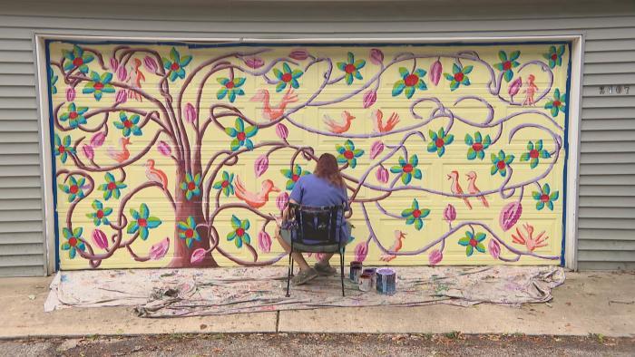Evanston artist Teresa Parod paints a mural on a garage door. (WTTW News)
