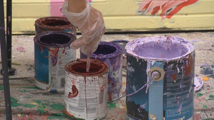 Evanston artist Teresa Parod paints a mural on a garage door. (WTTW News)