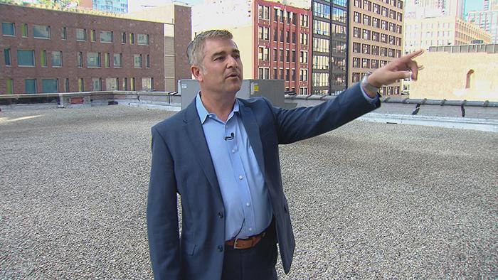 Ed Rossini on the roof of Palmer Printing, pointing to the business’ former location on Federal Street.