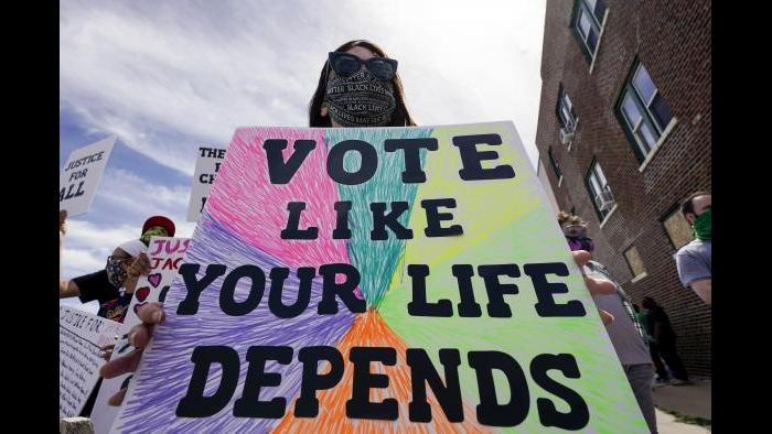 Amanda Becker holds a sign at a rally for Jacob Blake on Saturday, Aug. 29, 2020, in Kenosha, Wis. (AP Photo / Morry Gash)