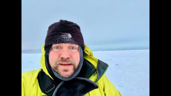 Scott Collis stands on ice sheet in Utqiagvik, Alaska, where temperatures can reach between minus 40 to minus 50 degrees. (Courtesy Scott Collis)