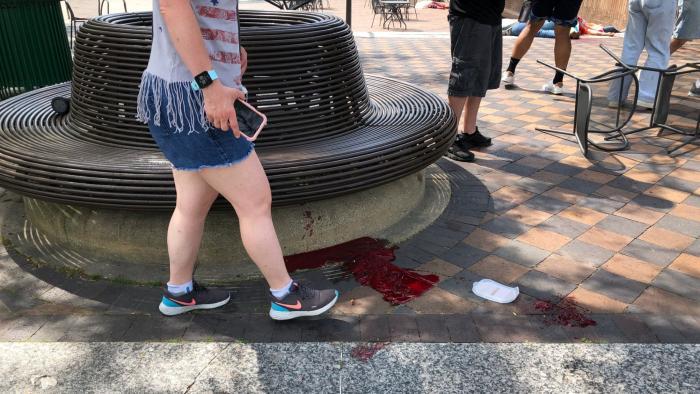 Blood pooled at Port Clinton Square in Highland Park, after a shooting at a July Fourth parade, in a Chicago suburb, Monday, July 4, 2022. (Lynn Sweet / Chicago Sun-Times via AP)