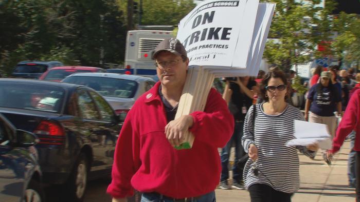 CPS teachers picked up strike materials such as shirts and signs at CTU headquarters Monday in preparation for a possible strike Tuesday morning.