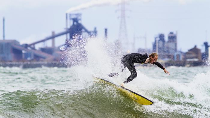A surfer rides the waves on the south end of Lake Michigan. (Credit: Mike Killion)