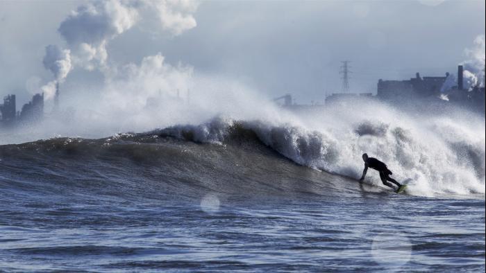 A surfer rides the waves on the south end of Lake Michigan. (Credit: Mike Killion)