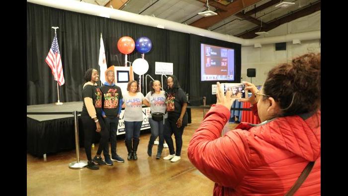 Supporters take photos in front of the candidate’s podium. (Evan Garcia / Chicago Tonight) 