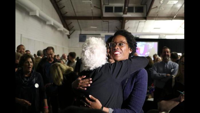 Democratic candidate Lauren Underwood makes her way through the crowd of supporters. (Evan Garcia / Chicago Tonight)