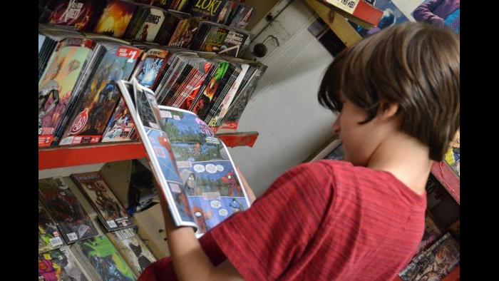 West Rogers Park resident Julian Kane looks at a Spiderman comic book. (Photo/Kristen Thometz)