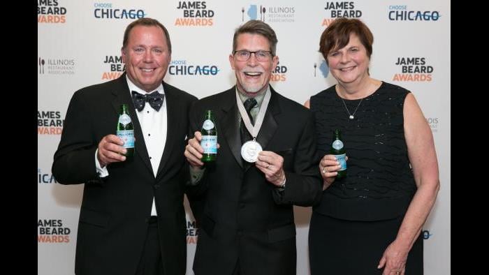 Rick Bayless, center, poses with his wife and business partner, Deann, and Dave Hardie, director of San Pellegrino. (Credit: Huge Galdones)