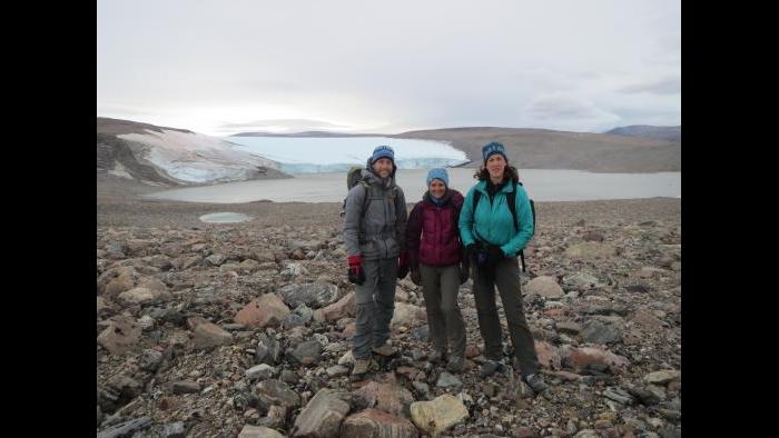 Northwestern Ph.D. students stand with Yarrow Axford in front of a glacier in Northwest Greenland near the Thule Air Base in August 2014. (Photo by Alex P. Taylor)