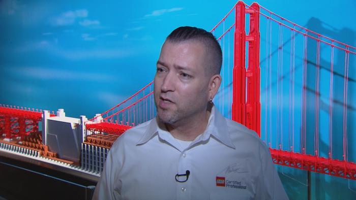 Tucker stands in front of his model of the Golden Gate Bridge.