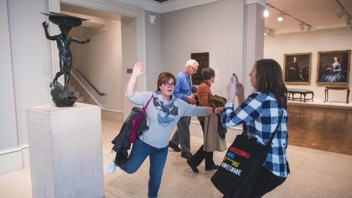 Guests imitate a sculpture on a Museum Hack tour. (Courtesy of Museum Hack)