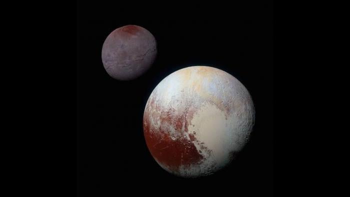 Pluto (lower right) and its moon Charon (upper left) (Courtesy of NASA/JHUAPL/SwRI)