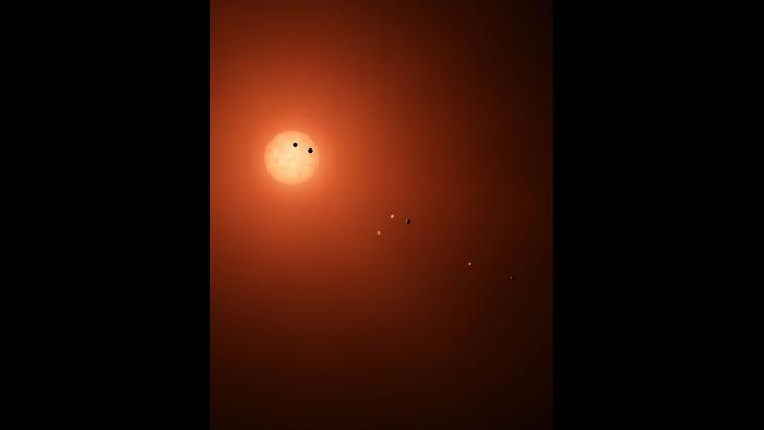 This illustration shows the seven TRAPPIST-1 planets as they might look as viewed from Earth using a fictional, incredibly powerful telescope. (NASA / JPL-Caltech)