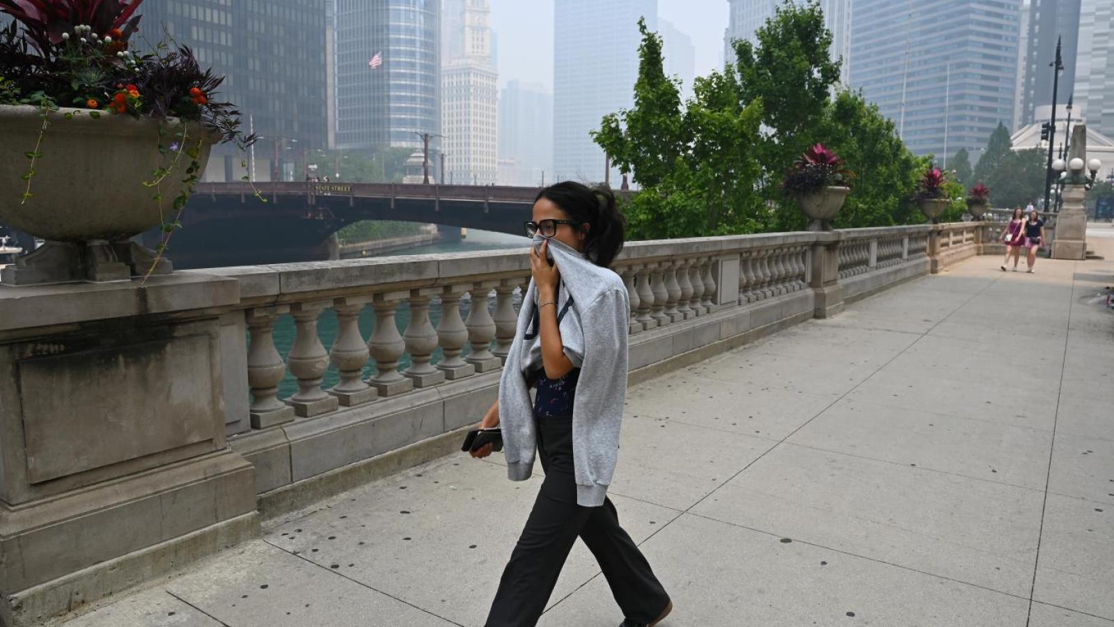 Pedestrians in downtown Chicago opt for masks amid hazardous air quality alerts on July 16, 2026. (Victor Hilitski / WTTW News)