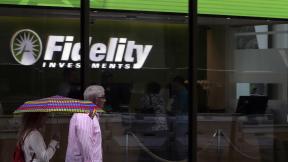In this June 18, 2019, photo people walk past Fidelity Investments news scroll board, showing a favorable outlook in the US stock markets, in the Financial District of Boston. (AP Photo / Charles Krupa) In this June 18, 2019, photo people walk past Fidelity Investments news scroll board, showing a favorable outlook in the US stock markets, in the Financial District of Boston. (AP Photo / Charles Krupa)