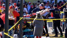 A woman is taken to an ambulance after an incident following the Kansas City Chiefs NFL football Super Bowl celebration in Kansas City, Mo., Wednesday, Feb. 14, 2024. (Reed Hoffmann / AP Photo)