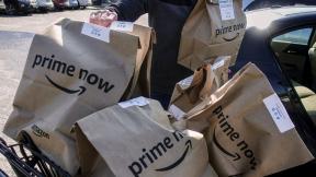 Amazon Prime Now bags are loaded for delivery outside a Whole Foods store on Feb. 8, 2018, in Cincinnati. (AP Photo / John Minchillo, File)