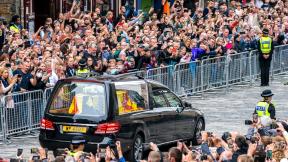 The hearse carrying the coffin of Queen Elizabeth II, draped with the Royal Standard of Scotland, passes the City Chambers on the Royal Mile, Edinburgh, Sunday, Sept. 11, 2022 on the journey from Balmoral to the Palace of Holyroodhouse in Edinburgh, where it will lie in rest for a day. (Jane Barlow / Pool Photo via AP) The hearse carrying the coffin of Queen Elizabeth II, draped with the Royal Standard of Scotland, passes the City Chambers on the Royal Mile, Edinburgh, Sunday, Sept. 11, 2022 on the journey from Balmoral to the Palace of Holyroodhouse in Edinburgh, where it will lie in rest for a day. (Jane Barlow / Pool Photo via AP)