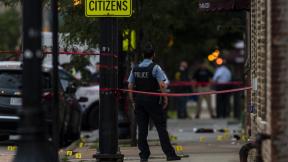 Chicago police investigate the scene of a mass shooting where more then a dozen people were shot in the Gresham neighborhood, of Chicago, Tuesday, July 21, 2020. (Tyler LaRiviere/Chicago Sun-Times via AP) Chicago police investigate the scene of a mass shooting where more then a dozen people were shot in the Gresham neighborhood, of Chicago, Tuesday, July 21, 2020. (Tyler LaRiviere/Chicago Sun-Times via AP)