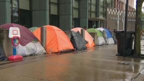 Migrants are sleeping in tents outside Chicago police stations. (WTTW News)