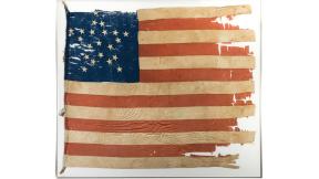 This image provided by Heritage Auctions, shows 21-star U.S. flag. Illinois state investigators are scrutinizing the purchase by the Abraham Lincoln Presidential Library and Museum of this 21-star U.S. flag reportedly from 1818-1819 at the time that Illinois was admitted to the Union as the 21st state. At the same time, one of the nation’s top vexillologists, or flag experts, says the flag is not from 1818 but from the Civil War period and is likely a so-called Southern exclusionary flag, reserving on its b