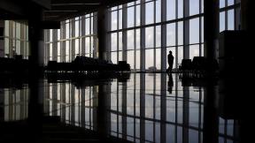 In this June 1, 2020 file photo, a woman looks through a window at a near-empty terminal at an airport in Atlanta. The coronavirus pandemic has taken a harsh toll on the mental health of young Americans, according to a new poll. (AP Photo/Charlie Riedel, File) In this June 1, 2020 file photo, a woman looks through a window at a near-empty terminal at an airport in Atlanta. The coronavirus pandemic has taken a harsh toll on the mental health of young Americans, according to a new poll. (AP Photo/Charlie Riedel, File)