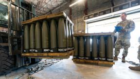 U.S. Air Force Staff Sgt. Cody Brown, right, with the 436th Aerial Port Squadron, checks pallets of 155 mm shells ultimately bound for Ukraine, Friday, April 29, 2022, at Dover Air Force Base, Del. (AP Photo / Alex Brandon)
