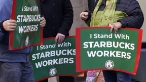 Arlene Geiger, left, holds a sign supporting Starbucks workers outside a Starbucks on New York's Upper West Side, Thursday, Nov. 16, 2023. Thousands of workers at more than 200 U.S. Starbucks stores plan to walk off the job Thursday in what organizers say is the largest strike yet in the two-year-old effort to unionize the company's stores. (AP Photo/Richard Drew) Arlene Geiger, left, holds a sign supporting Starbucks workers outside a Starbucks on New York's Upper West Side, Thursday, Nov. 16, 2023. Thousands of workers at more than 200 U.S. Starbucks stores plan to walk off the job Thursday in what organizers say is the largest strike yet in the two-year-old effort to unionize the company's stores. (AP Photo/Richard Drew)