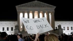 A crowd of people gather outside the Supreme Court, Monday night, May 2, 2022 in Washington. (AP Photo / Alex Brandon)
