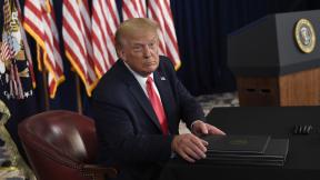 President Donald Trump prepares to sign four executive orders during a news conference at the Trump National Golf Club in Bedminster, N.J., Saturday, Aug. 8, 2020. (AP Photo/Susan Walsh) President Donald Trump prepares to sign four executive orders during a news conference at the Trump National Golf Club in Bedminster, N.J., Saturday, Aug. 8, 2020. (AP Photo/Susan Walsh)