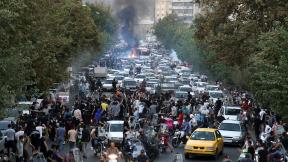 Protesters chant slogans during a protest over the death of a woman who was detained by the morality police, in downtown Tehran, Iran, on Sept. 21, 2022. (Associated Press) Protesters chant slogans during a protest over the death of a woman who was detained by the morality police, in downtown Tehran, Iran, on Sept. 21, 2022. (Associated Press)